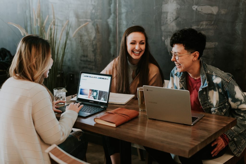 people sitting at table working.