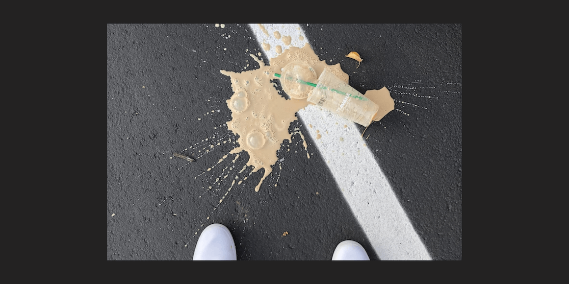 Starbucks coffee spilled on pavement